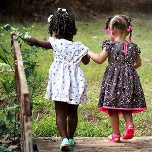 Two little girls walking away together as friends. Representing The Right to Feel Safe
