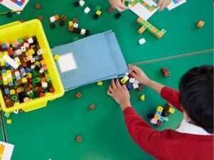 Little boy learning maths with bricks. Representing Teacher Assessment Judgements in Mathematics