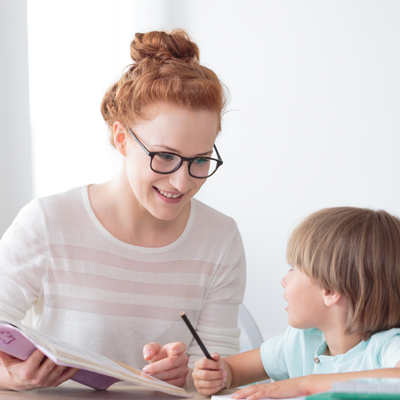 Woman teaching a little boy. Representing Phonics Screening Check – Administering the Check