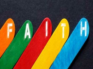 5 colourful lollipop sticks spelling out the word "Faith" representing Understanding RE in Birmingham