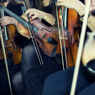 Group of people getting ready to play violins