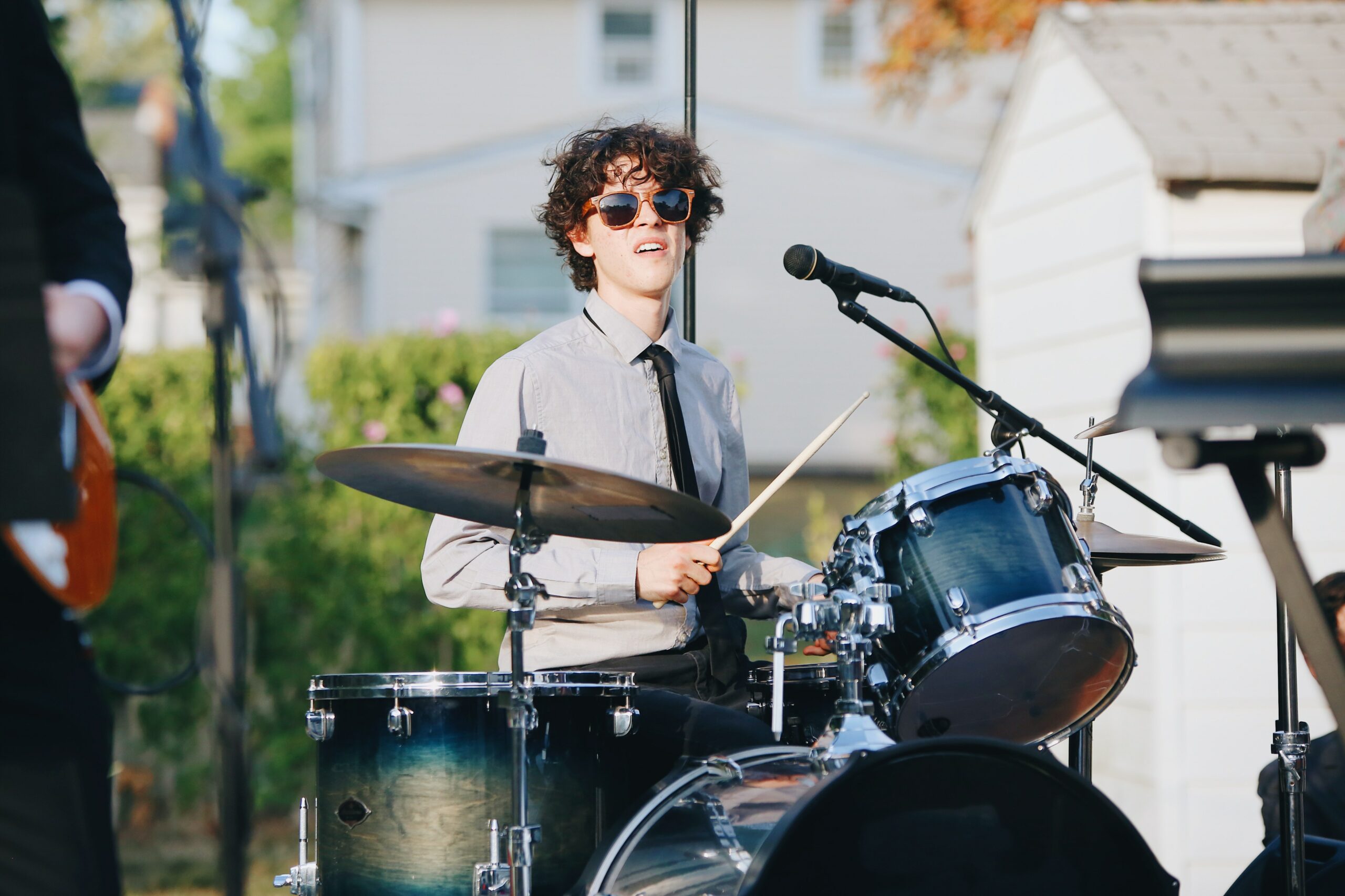 Teenager playing the drums to symbolise drum lessons at a music school.