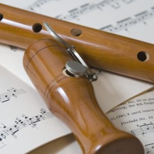 wooden recorder on a sheet of music