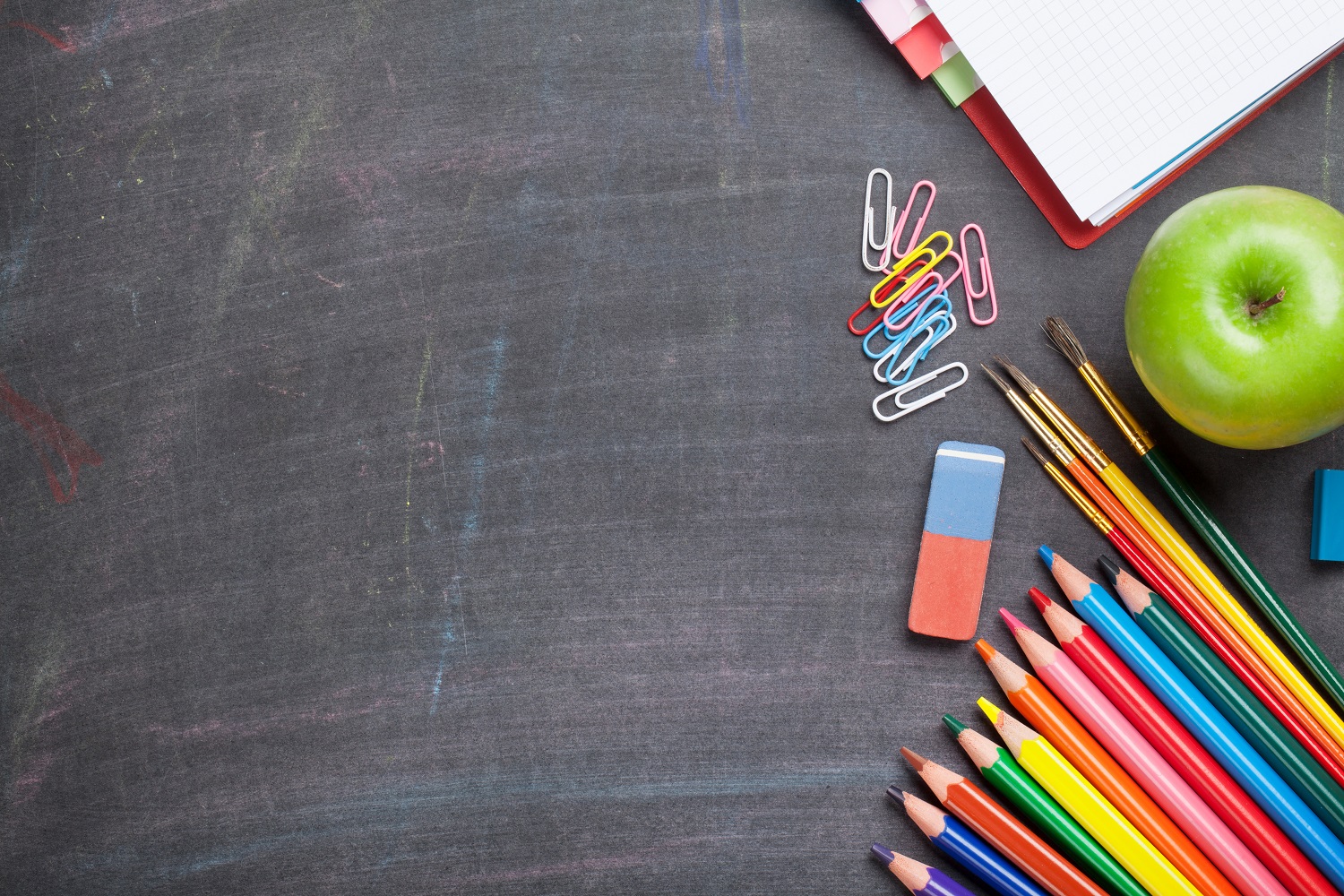 School supplies on blackboard background